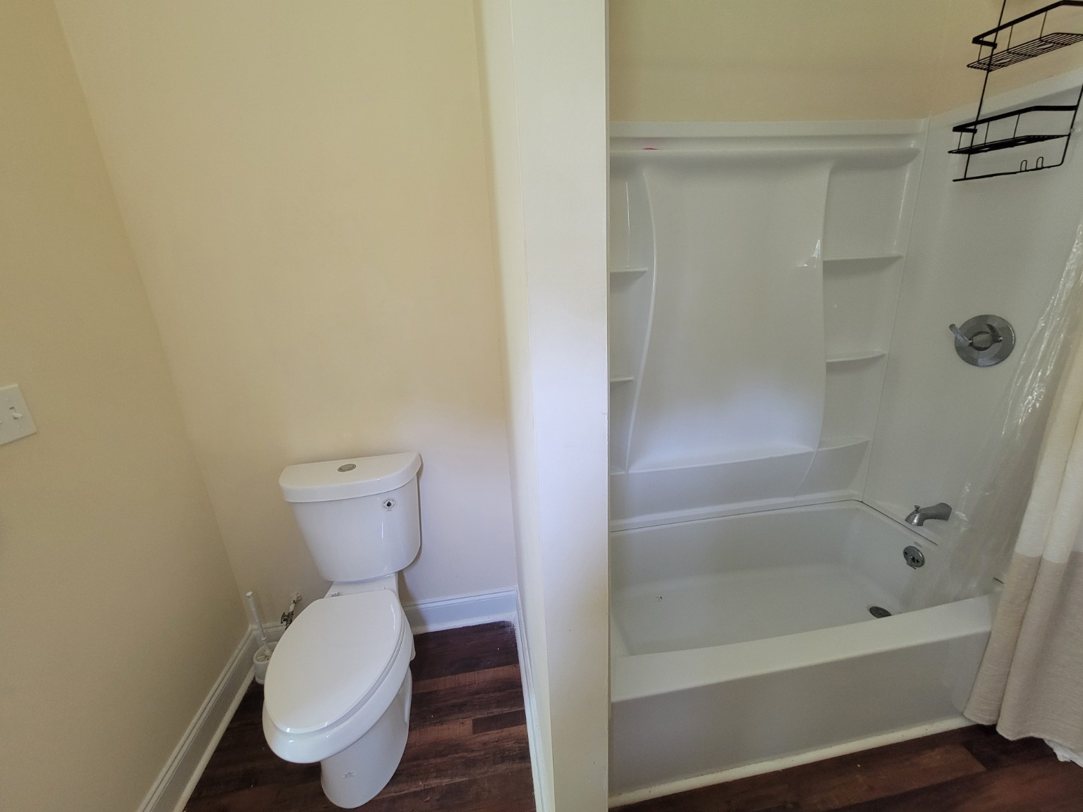 Primary Bathroom — Toilet and Tub/Shower